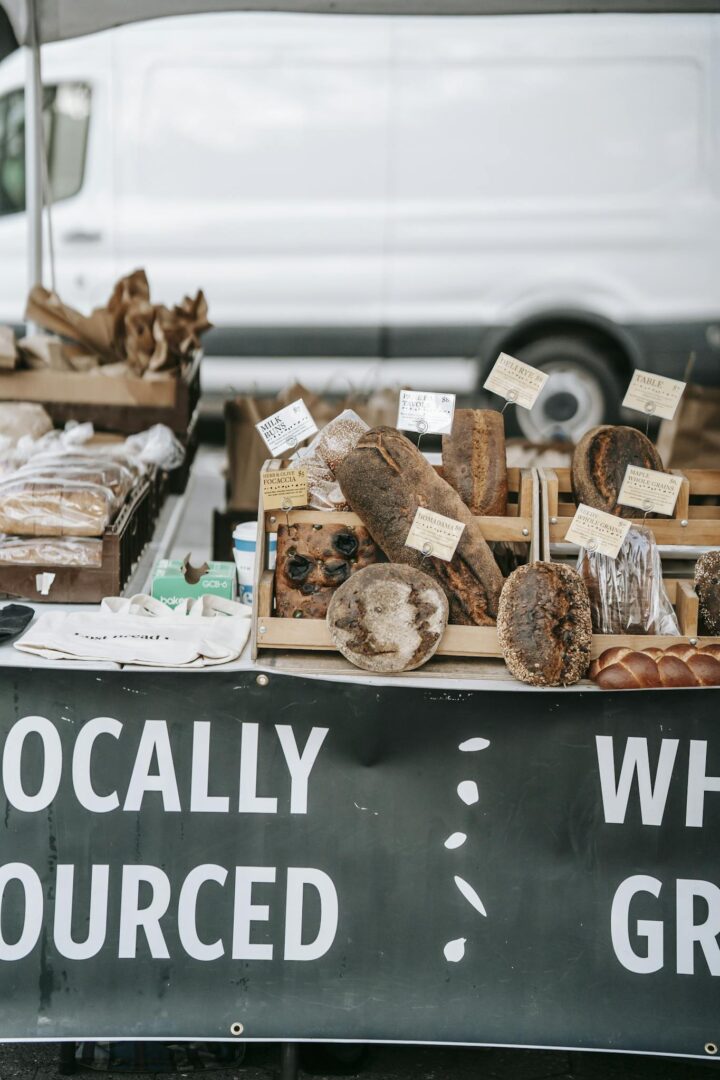 Different delicious fresh breads and loaves placed on wooden trays in small street bakery